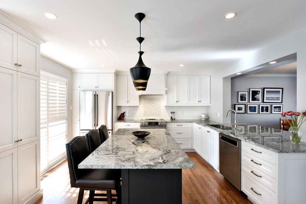 Inspiration for a large transitional u-shaped light wood floor and beige floor open concept kitchen remodel in Ottawa with an undermount sink, shaker cabinets, white cabinets, granite countertops, white backsplash, subway tile backsplash, stainless steel appliances, an island and gray countertops