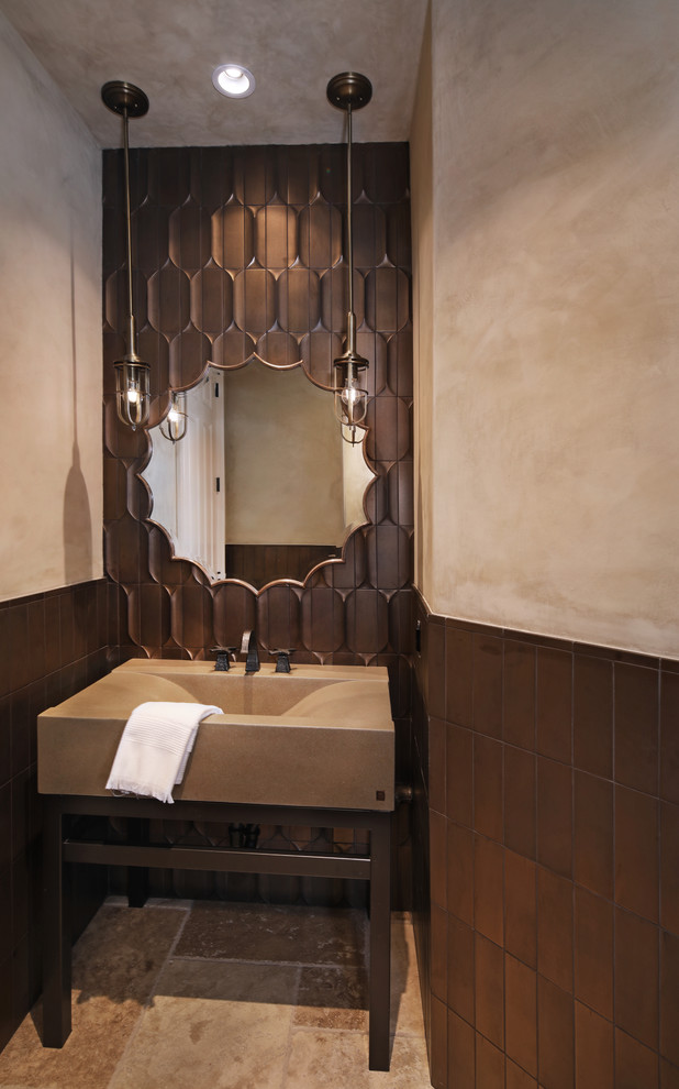 Design ideas for a mid-sized transitional powder room in Orange County with a one-piece toilet, travertine floors, an integrated sink, concrete benchtops and brown floor.
