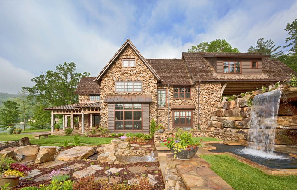 This is an example of a country exterior in Other with stone veneer.