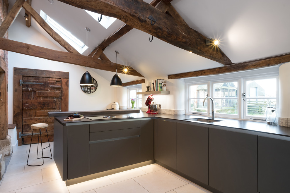 Inspiration for a mid-sized eclectic l-shaped separate kitchen in Gloucestershire with a single-bowl sink, flat-panel cabinets, grey cabinets, quartzite benchtops, beige splashback, panelled appliances, porcelain floors and mosaic tile splashback.