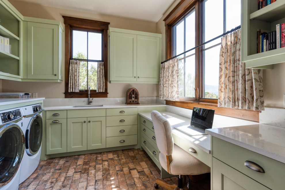 Traditional u-shaped utility room in Salt Lake City with an undermount sink, shaker cabinets, green cabinets, beige walls, a side-by-side washer and dryer, brown floor and white benchtop.