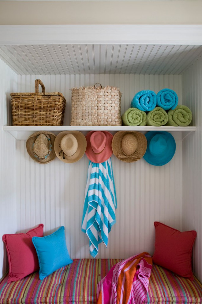 Design ideas for a beach style mudroom in DC Metro with white walls.