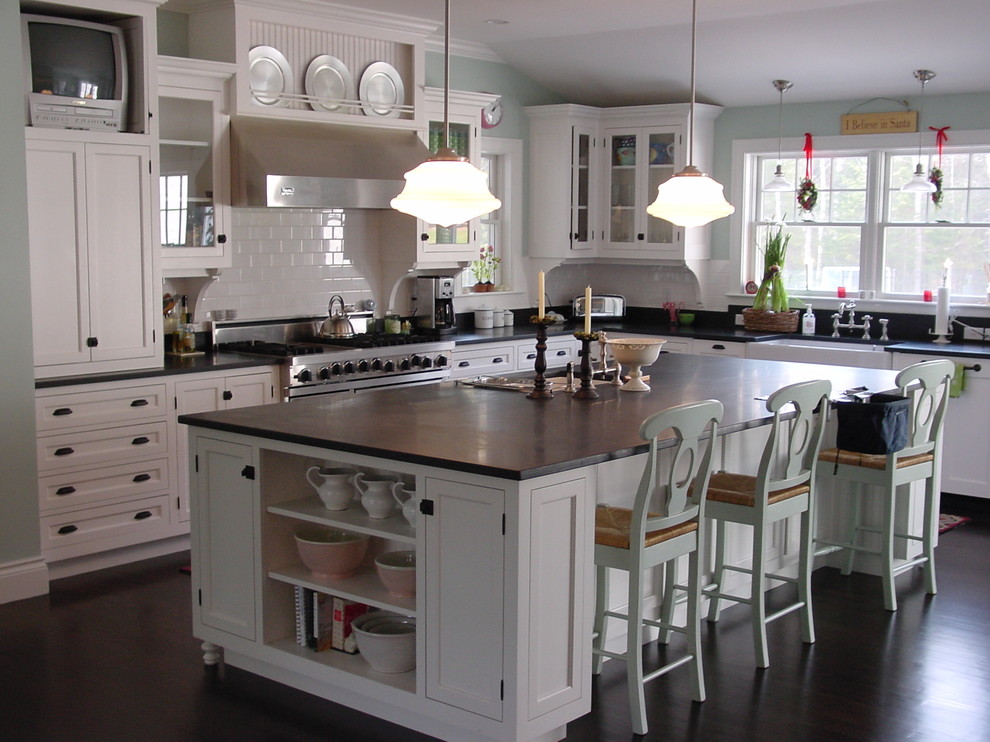 This is an example of an expansive traditional l-shaped separate kitchen in Portland Maine with a farmhouse sink, beaded inset cabinets, white cabinets, granite benchtops, white splashback, subway tile splashback, stainless steel appliances, dark hardwood floors and with island.