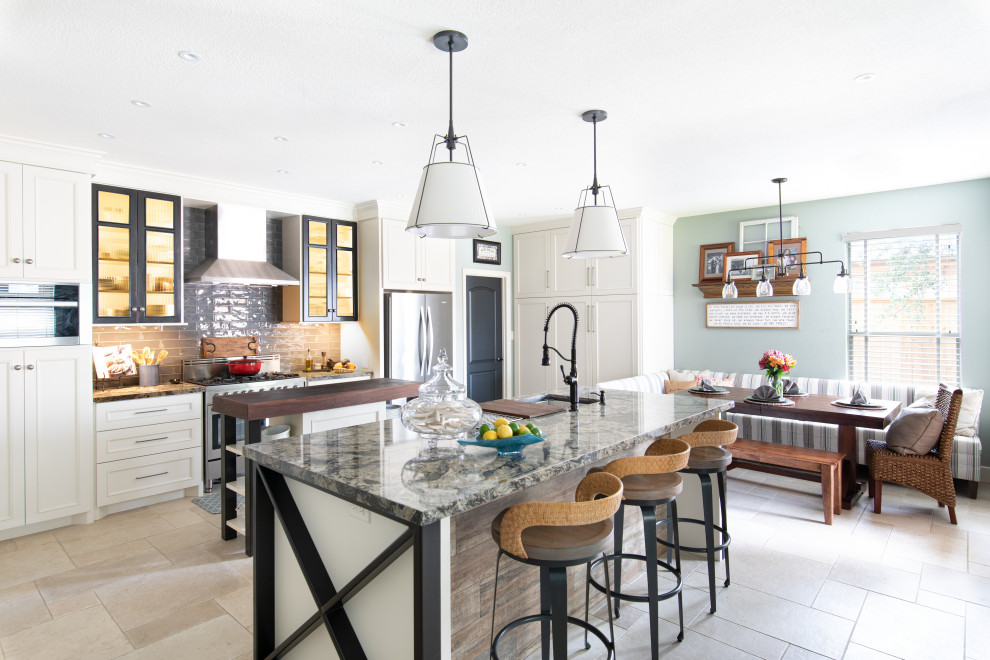 Large beach style l-shaped eat-in kitchen in Austin with an undermount sink, glass-front cabinets, white cabinets, quartz benchtops, grey splashback, ceramic splashback, stainless steel appliances, ceramic floors, multiple islands, beige floor and multi-coloured benchtop.