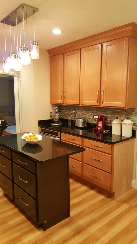 Kitchen - transitional light wood floor kitchen idea in Boston with an undermount sink, shaker cabinets, granite countertops, glass tile backsplash, stainless steel appliances and an island