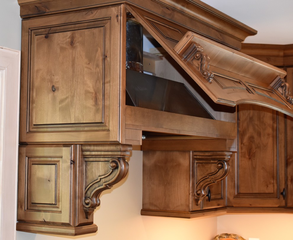 Example of a huge mountain style kitchen design with distressed cabinets