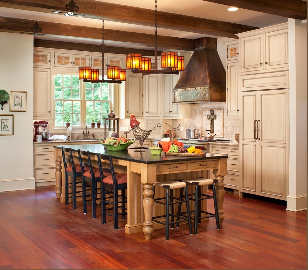 Inspiration for a mid-sized country l-shaped open plan kitchen in Nashville with an undermount sink, raised-panel cabinets, light wood cabinets, beige splashback, ceramic splashback, stainless steel appliances, medium hardwood floors, with island and brown floor.