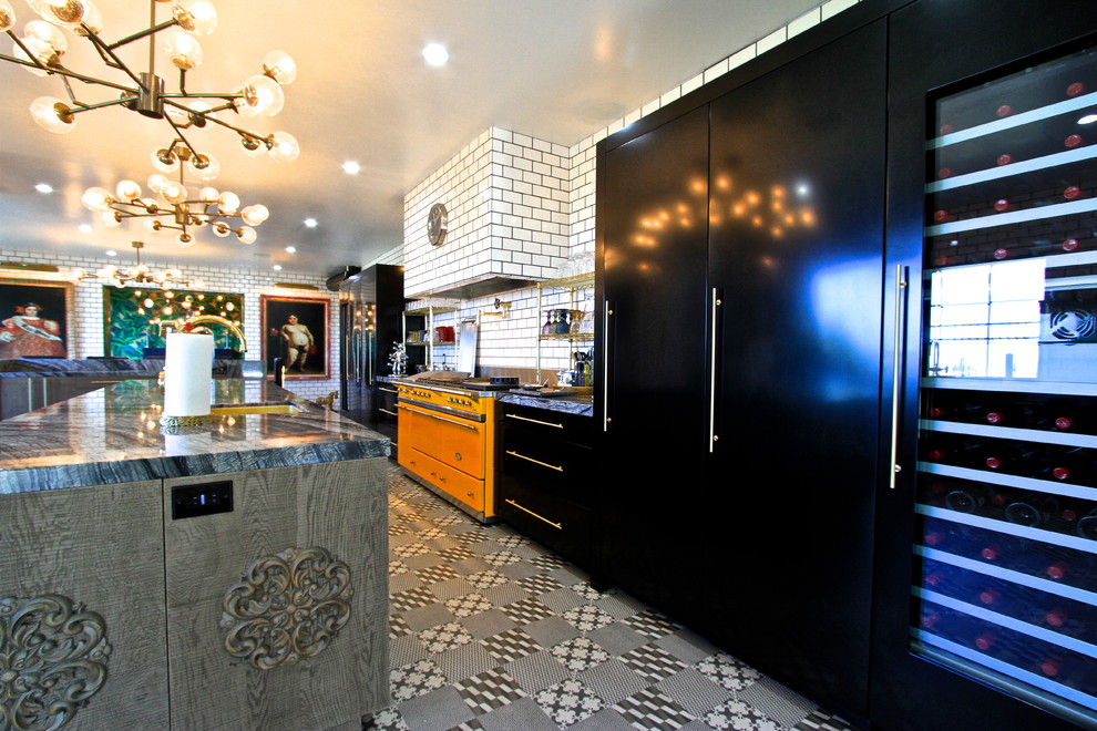 Example of a huge eclectic l-shaped ceramic tile enclosed kitchen design in Orange County with an undermount sink, flat-panel cabinets, gray cabinets, marble countertops, white backsplash, subway tile backsplash, black appliances and an island
