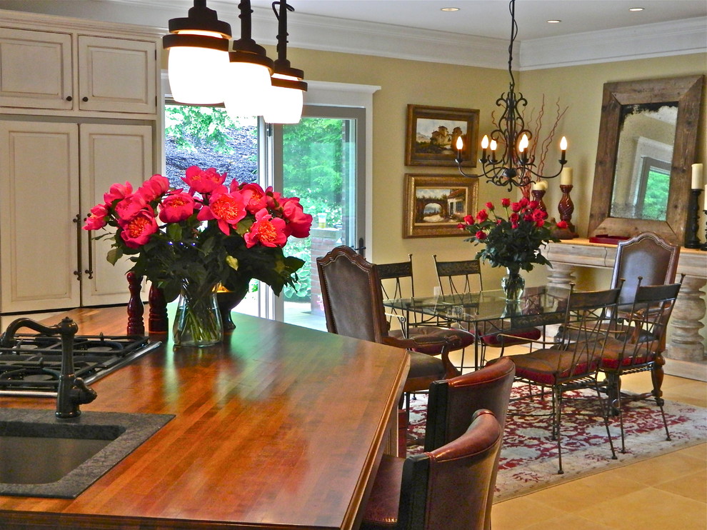 Eat-in kitchen - large rustic l-shaped limestone floor eat-in kitchen idea with an island, beaded inset cabinets, red cabinets, soapstone countertops, multicolored backsplash, terra-cotta backsplash, paneled appliances and a farmhouse sink