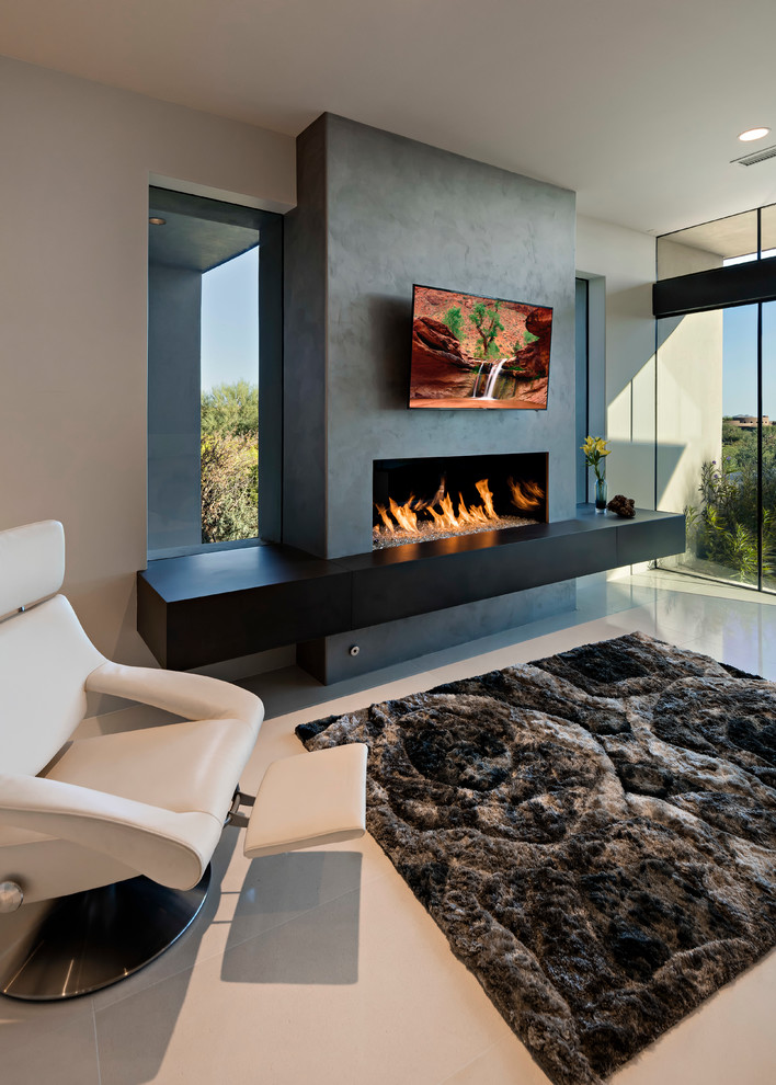 Design ideas for a large modern master bedroom in Phoenix with beige walls, porcelain floors, a ribbon fireplace and a concrete fireplace surround.