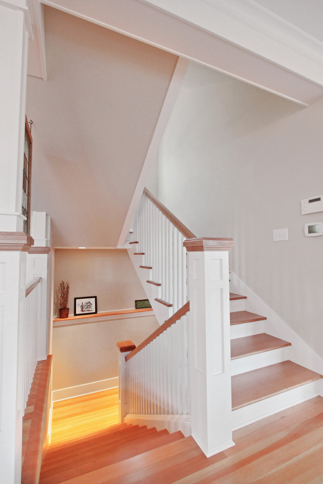 Design ideas for a mid-sized arts and crafts wood u-shaped staircase in Seattle with wood risers and wood railing.