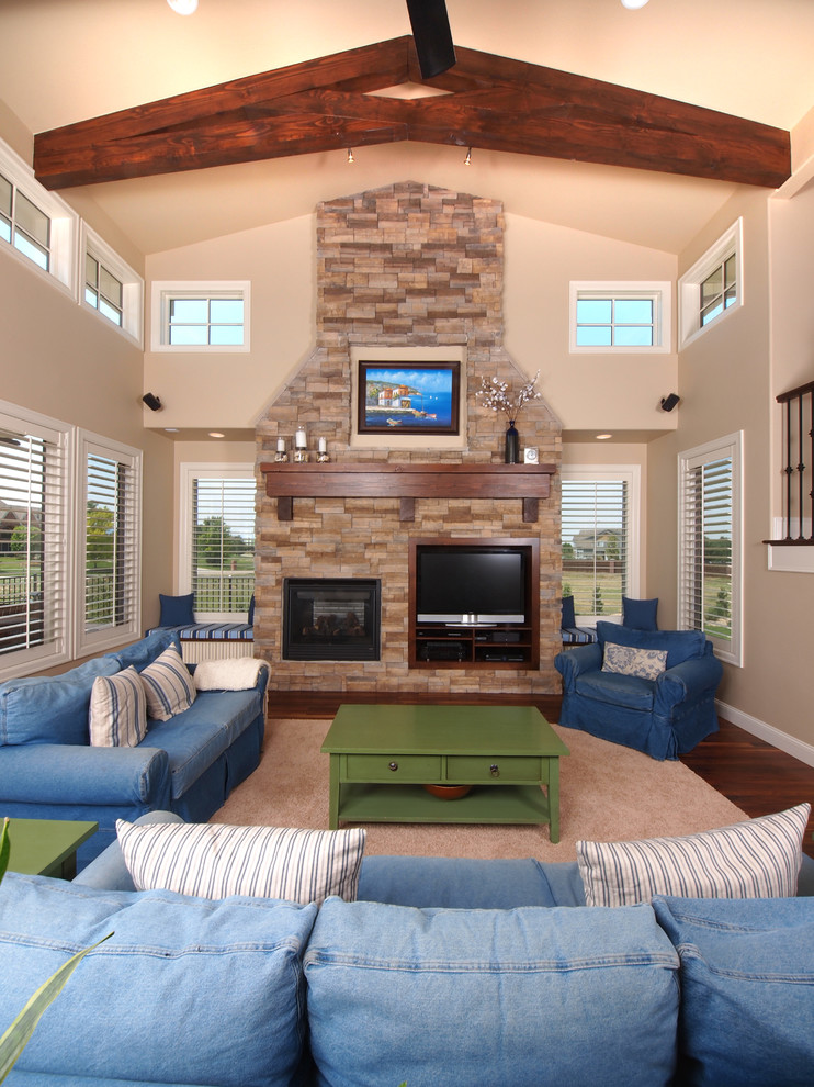Design ideas for a traditional family room in Denver with beige walls, dark hardwood floors, a standard fireplace, a stone fireplace surround and a wall-mounted tv.