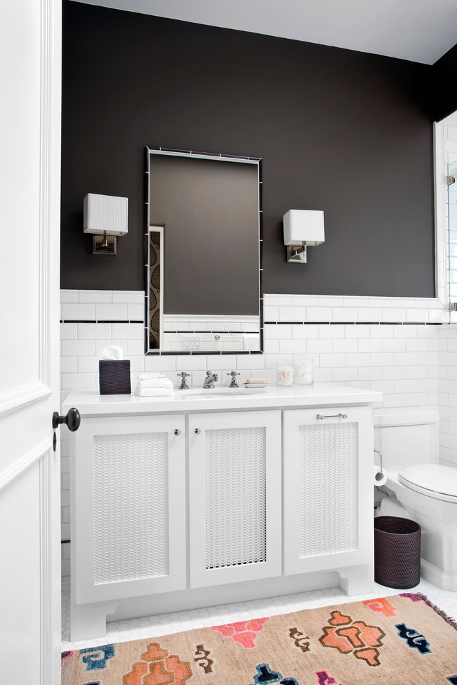 Design ideas for a transitional bathroom in Los Angeles with white tile, subway tile, an undermount sink, shaker cabinets, white cabinets, a one-piece toilet, black walls and mosaic tile floors.