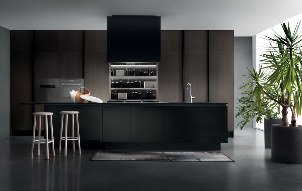 Design ideas for a large modern single-wall kitchen pantry in Toronto with an integrated sink, flat-panel cabinets, black cabinets, quartz benchtops, panelled appliances, concrete floors, with island, grey splashback, stone slab splashback and grey floor.