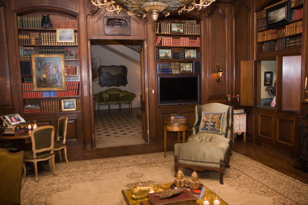 Inspiration for a traditional family room in Houston with dark hardwood floors and a built-in media wall.