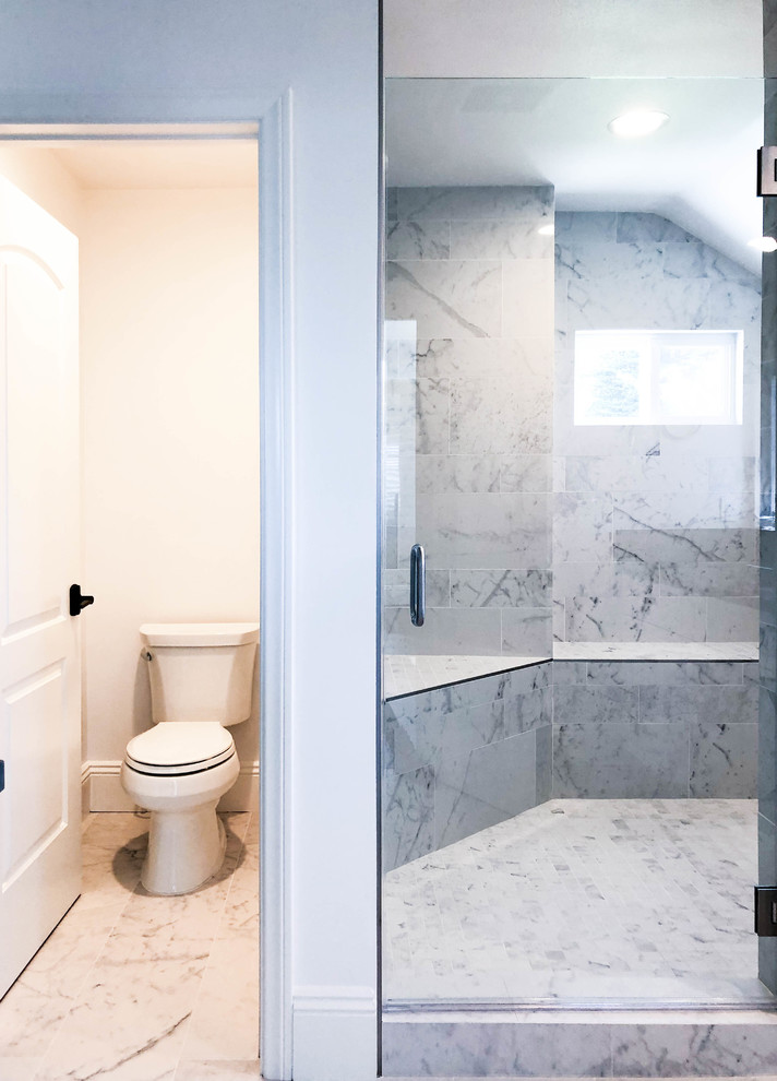 This is an example of a mid-sized contemporary master bathroom in Los Angeles with white cabinets, a two-piece toilet, beige tile, ceramic tile, beige walls, ceramic floors, beige floor, a hinged shower door, brown benchtops, recessed-panel cabinets, an alcove shower, engineered quartz benchtops, a shower seat and vaulted.