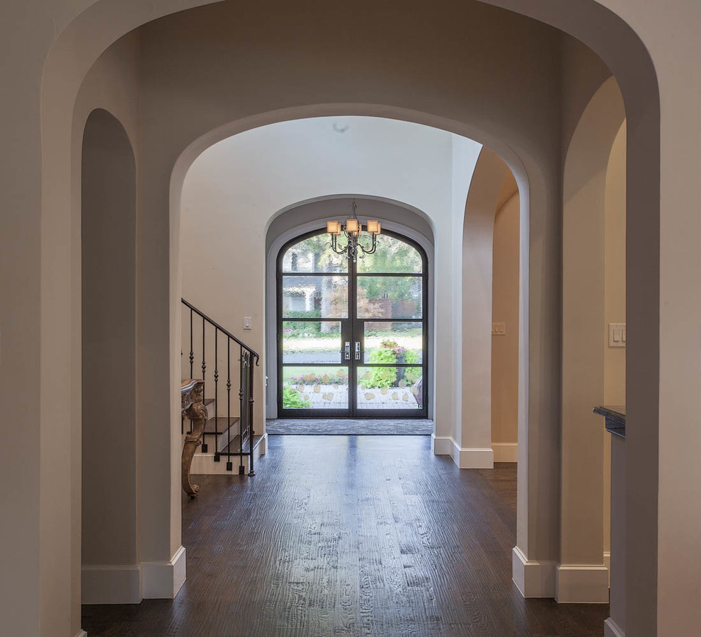 Large transitional dark wood floor and brown floor foyer photo in Dallas with white walls and a glass front door