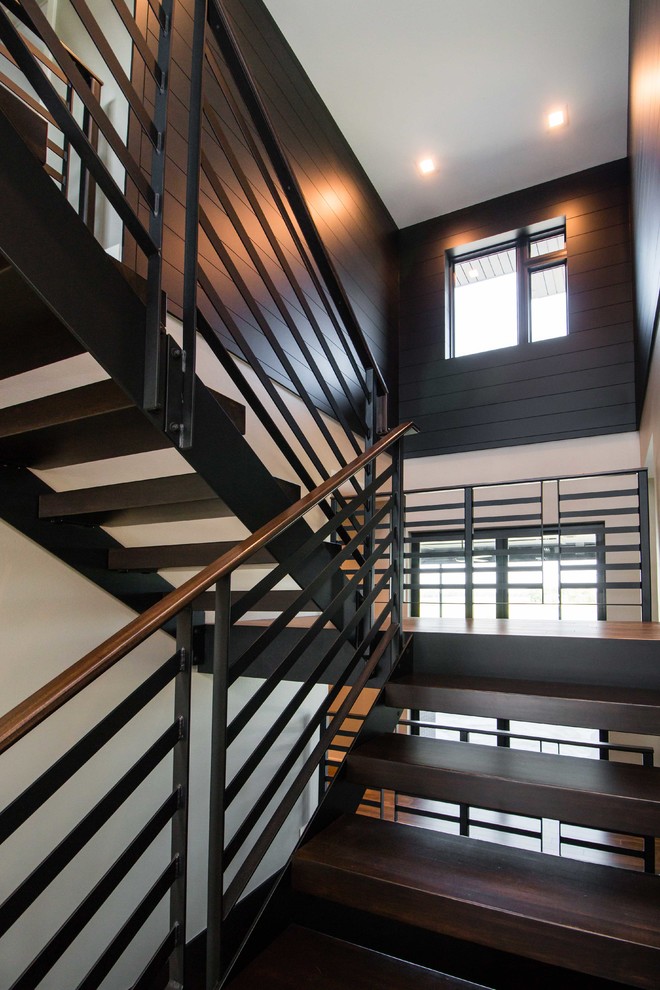 Design ideas for a large modern wood floating staircase in Other with open risers and metal railing.