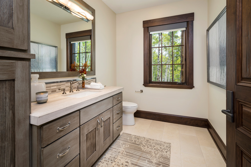Design ideas for an expansive country bathroom in Salt Lake City with grey cabinets, marble benchtops, recessed-panel cabinets, brown tile, mosaic tile, white walls, an undermount sink, beige floor and beige benchtops.