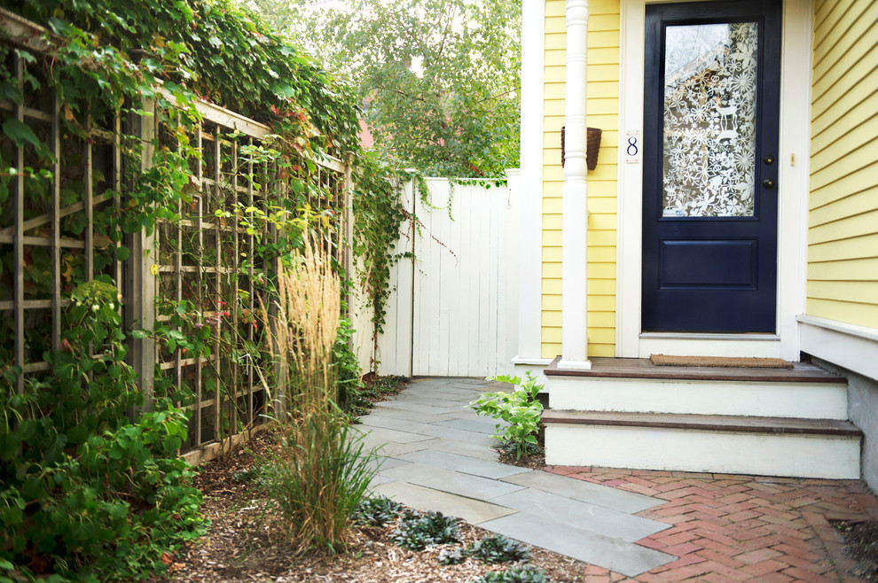 Inspiration for a small transitional front yard brick landscaping in Boston.