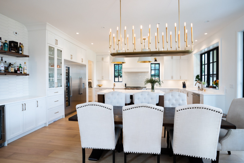 Inspiration for a mid-sized farmhouse light wood floor and beige floor kitchen/dining room combo remodel in Vancouver with white walls