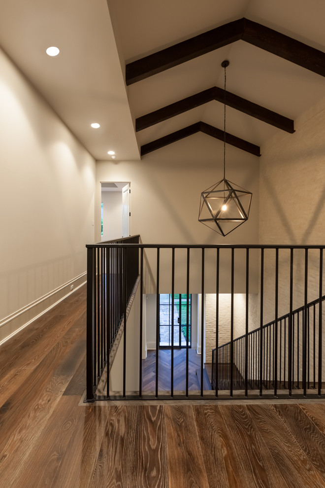 Inspiration for a large transitional medium tone wood floor hallway remodel in Houston with beige walls