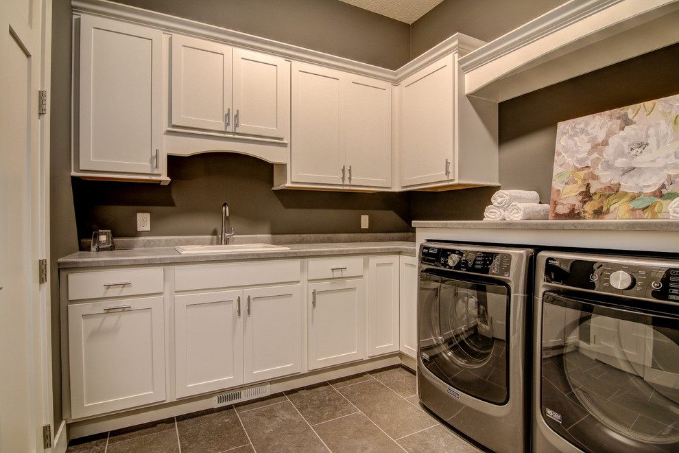 Inspiration for a large transitional laundry room in Minneapolis with a drop-in sink, recessed-panel cabinets, white cabinets, granite benchtops and dark hardwood floors.