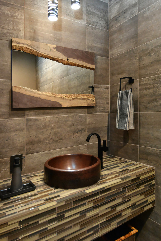 Inspiration for a mid-sized contemporary powder room in Tampa with a vessel sink, tile benchtops, gray tile, brown tile and multi-coloured benchtops.