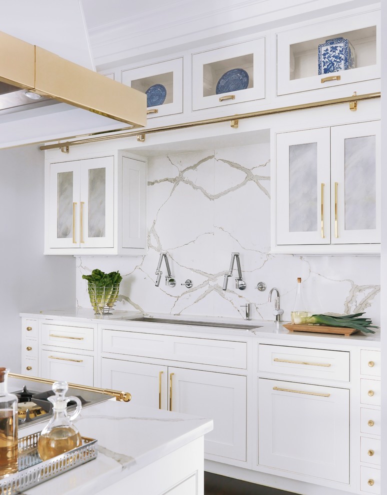 Inspiration for a large traditional eat-in kitchen in St Louis with a drop-in sink, blue cabinets, marble benchtops, grey splashback, marble splashback, white appliances, dark hardwood floors, multiple islands and brown floor.