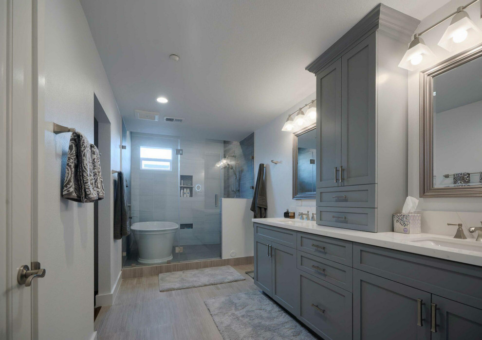 Bathroom - mid-sized traditional master gray tile and ceramic tile ceramic tile, gray floor and double-sink bathroom idea in Dallas with shaker cabinets, gray cabinets, white walls, a trough sink, quartzite countertops, a hinged shower door, white countertops, a niche and a built-in vanity