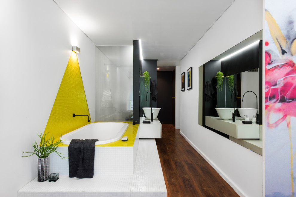 Photo of a small contemporary master bathroom in Sydney with white walls, linoleum floors, a vessel sink, solid surface benchtops, brown floor, flat-panel cabinets, white cabinets, a drop-in tub, yellow tile and mosaic tile.