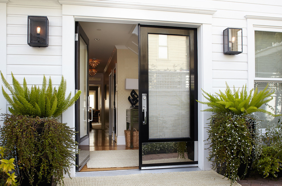This is an example of a large transitional front door in San Francisco with white walls, a double front door and a black front door.