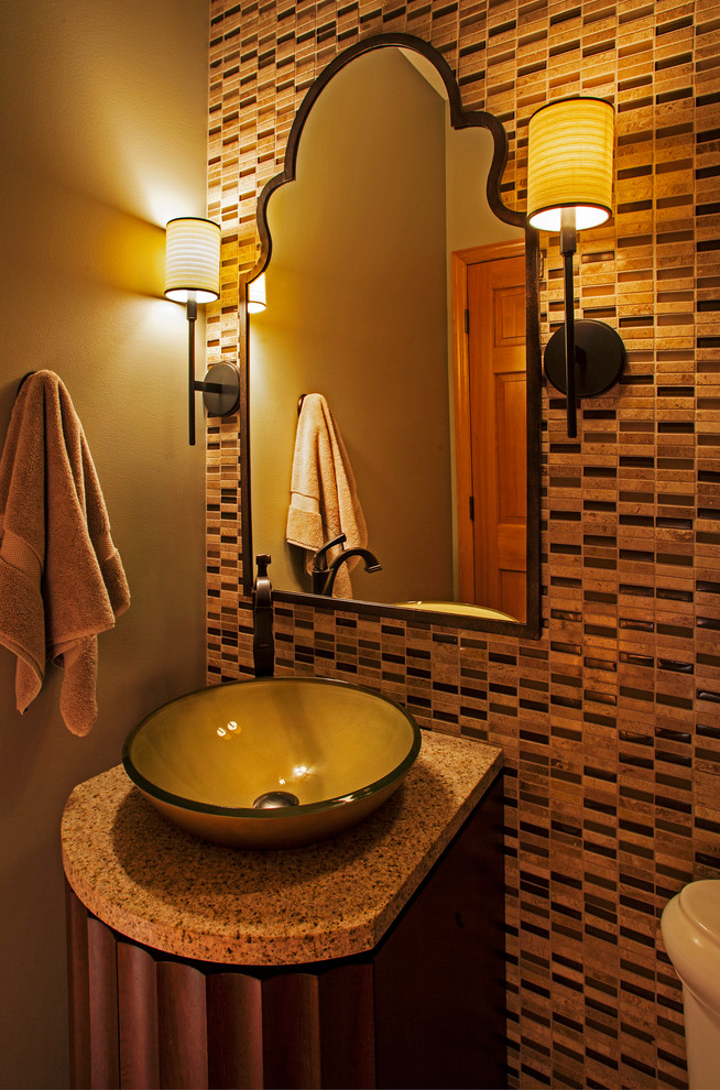 Small contemporary powder room in Minneapolis with flat-panel cabinets, medium wood cabinets, beige tile, brown tile, stone tile, brown walls, a vessel sink and granite benchtops.