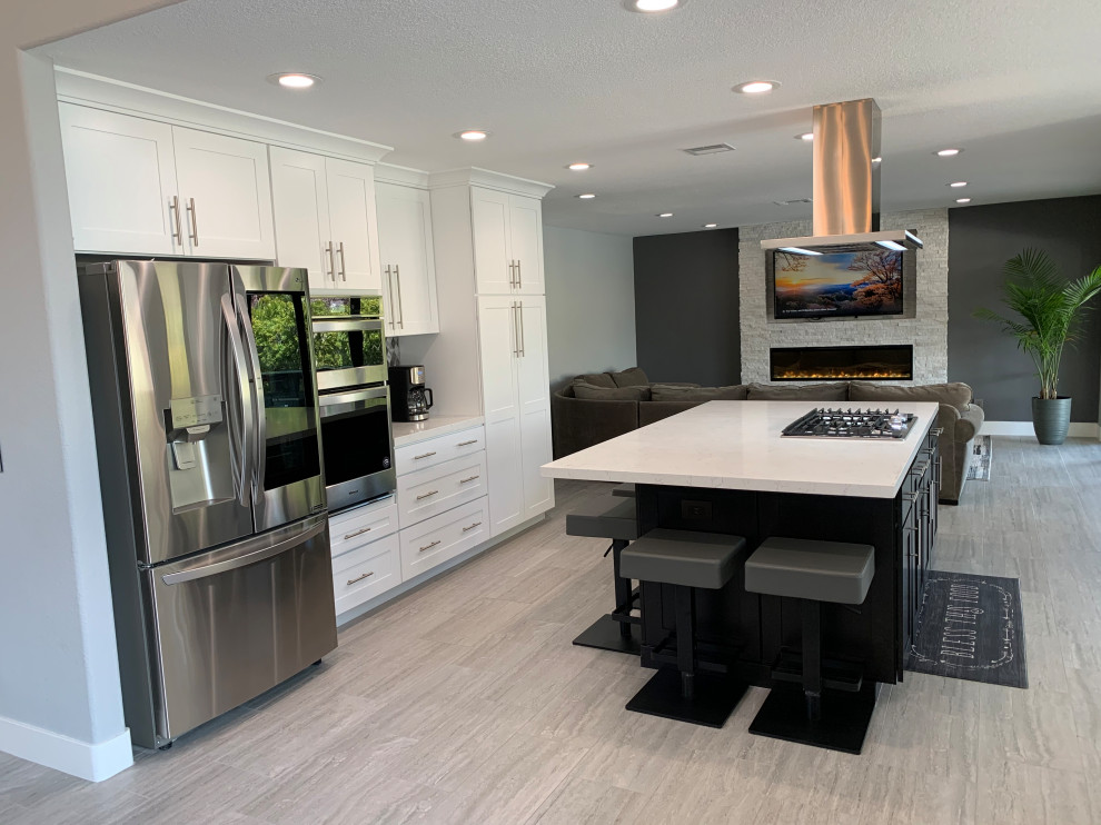 Inspiration for a mid-sized transitional single-wall eat-in kitchen remodel in Las Vegas with shaker cabinets, white cabinets, quartz countertops, stainless steel appliances, an island and white countertops