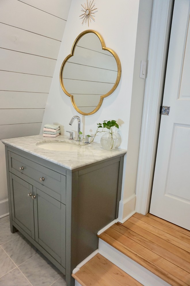 Inspiration for a mid-sized scandinavian master bathroom in Charleston with shaker cabinets, grey cabinets, a drop-in tub, a double shower, a one-piece toilet, white tile, marble, white walls, marble floors, an undermount sink, marble benchtops, grey floor, a sliding shower screen and grey benchtops.