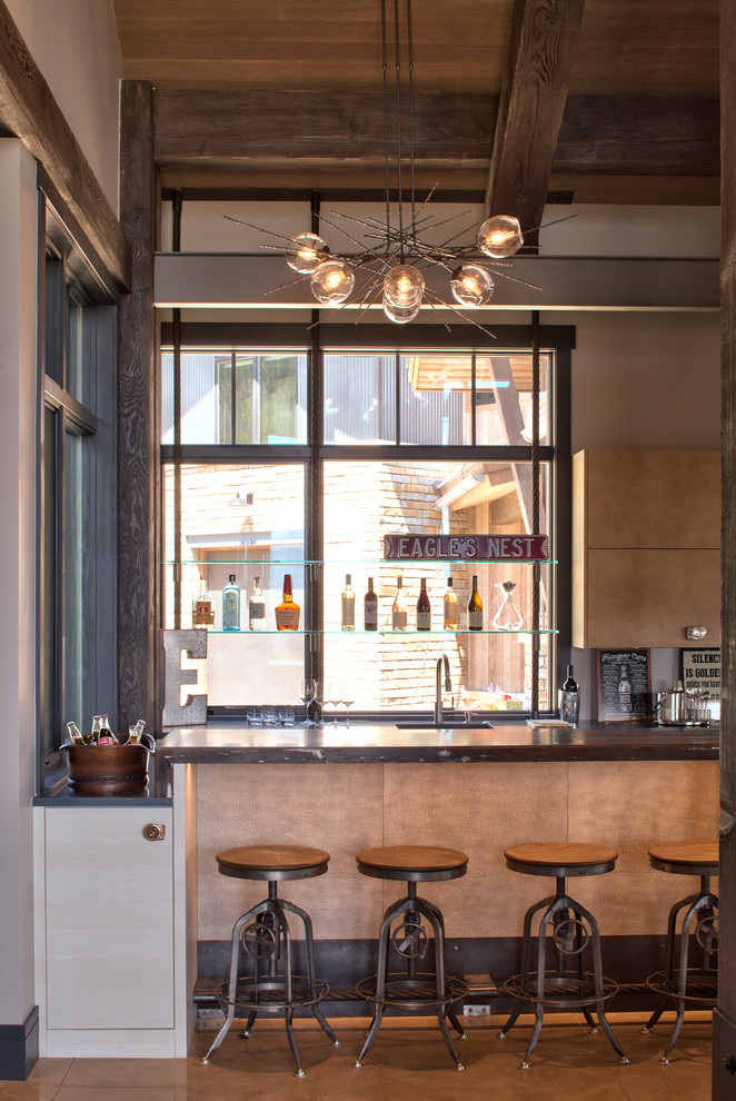 Inspiration for an eclectic home bar in Denver with flat-panel cabinets, beige cabinets, wood benchtops, concrete floors and brown benchtop.