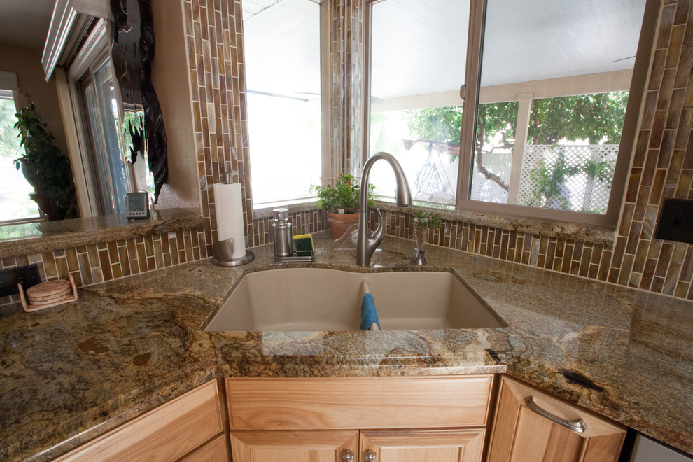Inspiration for a large transitional galley ceramic tile enclosed kitchen remodel in Phoenix with an undermount sink, recessed-panel cabinets, light wood cabinets, granite countertops, brown backsplash, glass tile backsplash and stainless steel appliances