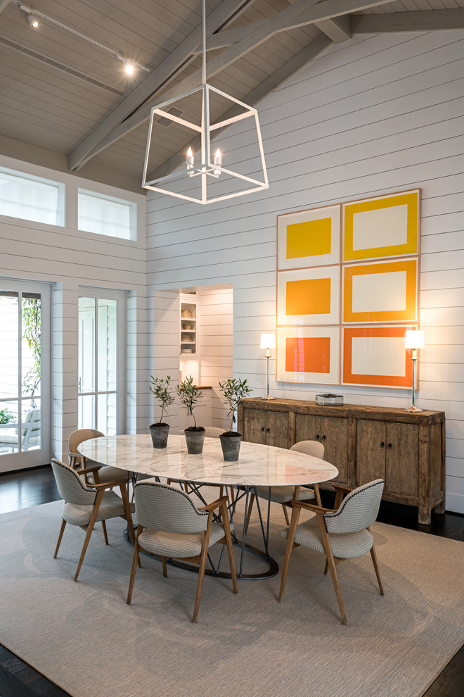 Inspiration for a large country separate dining room in Houston with white walls and dark hardwood floors.
