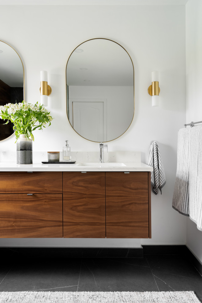 This is an example of a medium sized contemporary ensuite bathroom in Montreal with flat-panel cabinets, dark wood cabinets, a built-in shower, a one-piece toilet, brown tiles, wood-effect tiles, white walls, a submerged sink, engineered stone worktops, an open shower, white worktops, double sinks and a floating vanity unit.