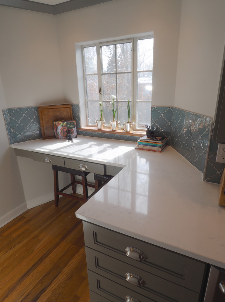 Mid-sized transitional eat-in kitchen in Denver with an undermount sink, recessed-panel cabinets, grey cabinets, quartz benchtops, blue splashback, glass tile splashback, stainless steel appliances and medium hardwood floors.