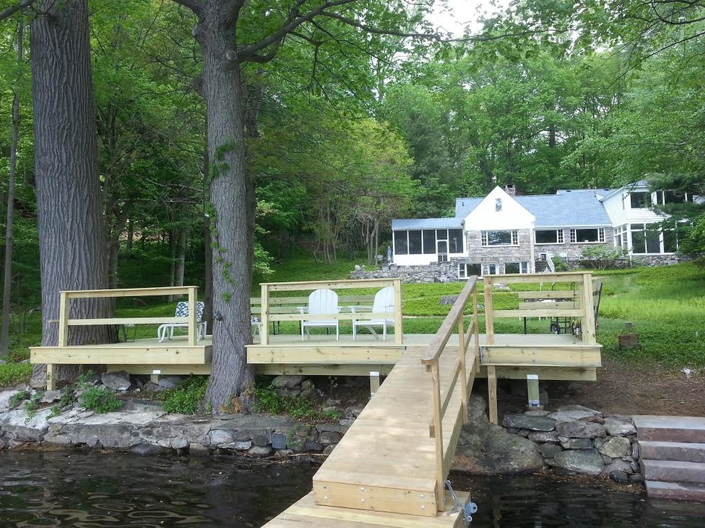 Large transitional backyard dock photo in New York with no cover