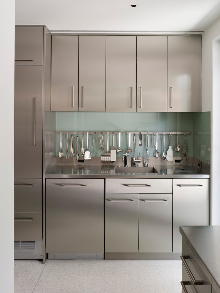 Design ideas for a mid-sized contemporary galley eat-in kitchen in Miami with an integrated sink, flat-panel cabinets, stainless steel cabinets, stainless steel benchtops, glass sheet splashback, with island, stainless steel appliances and concrete floors.