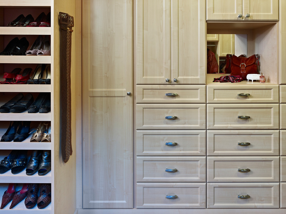 Photo of a large traditional gender-neutral dressing room in Denver with recessed-panel cabinets and light wood cabinets.