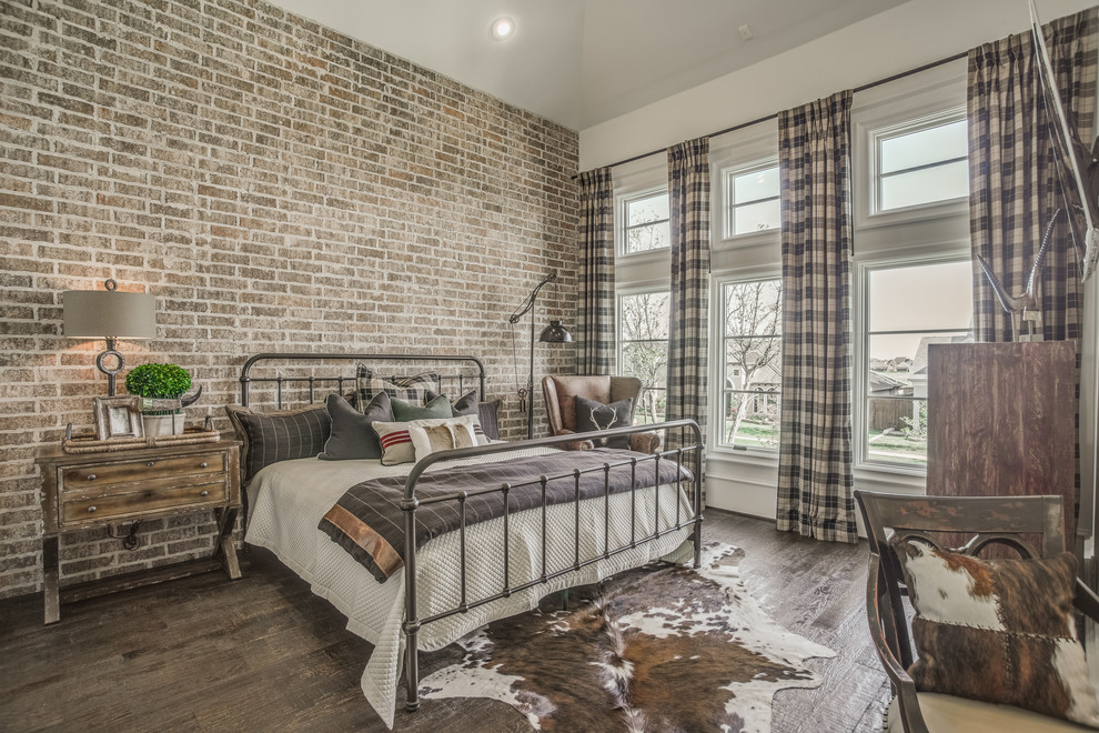 Large country guest bedroom in Austin with dark hardwood floors and no fireplace.
