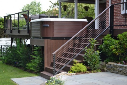 Photo of a mid-sized transitional backyard deck in New York with a roof extension.