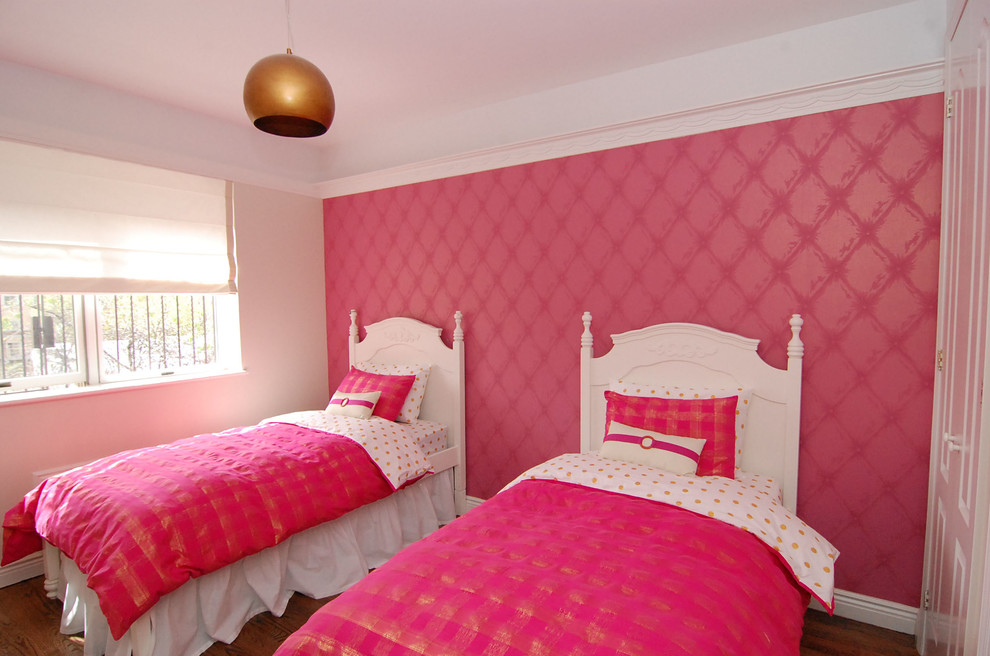 Mid-sized contemporary kids' bedroom in New York with pink walls and medium hardwood floors for kids 4-10 years old and girls.