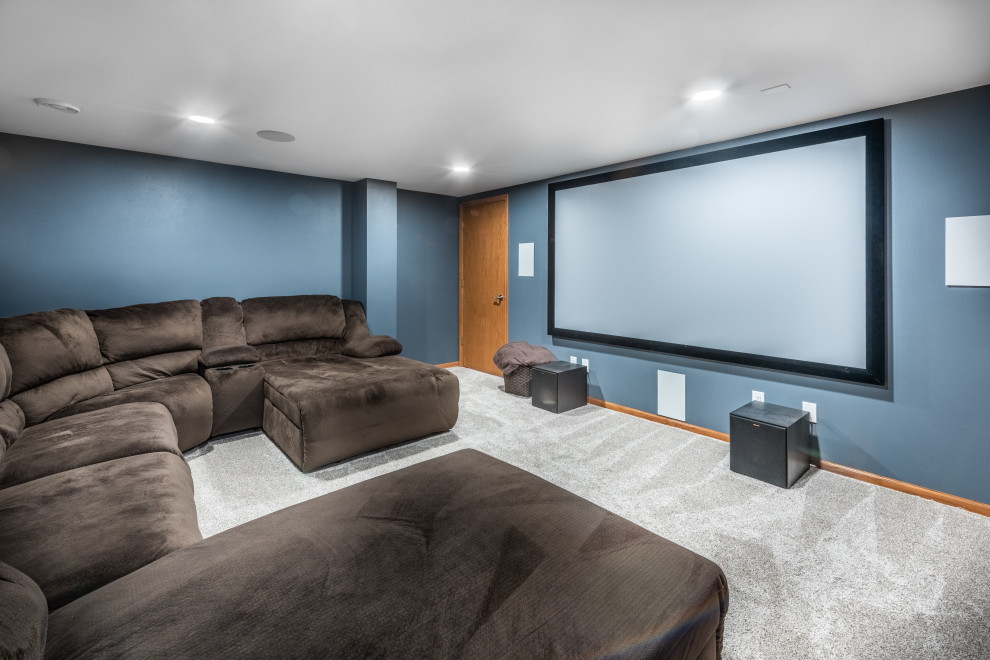 Design ideas for a medium sized contemporary open plan home cinema in Other with blue walls, carpet and a projector screen.
