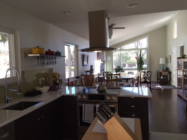 Inspiration for a mid-sized contemporary u-shaped ceramic tile and white floor eat-in kitchen remodel in Denver with an undermount sink, flat-panel cabinets, white cabinets, solid surface countertops, stainless steel appliances and a peninsula