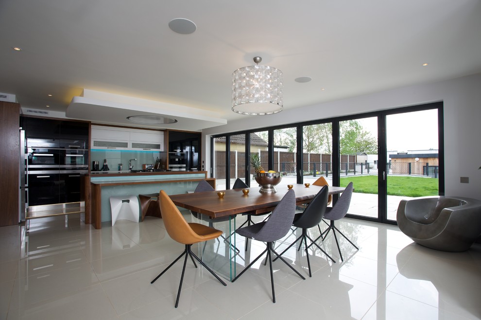 Inspiration for a contemporary kitchen/dining combo in Essex with white walls.