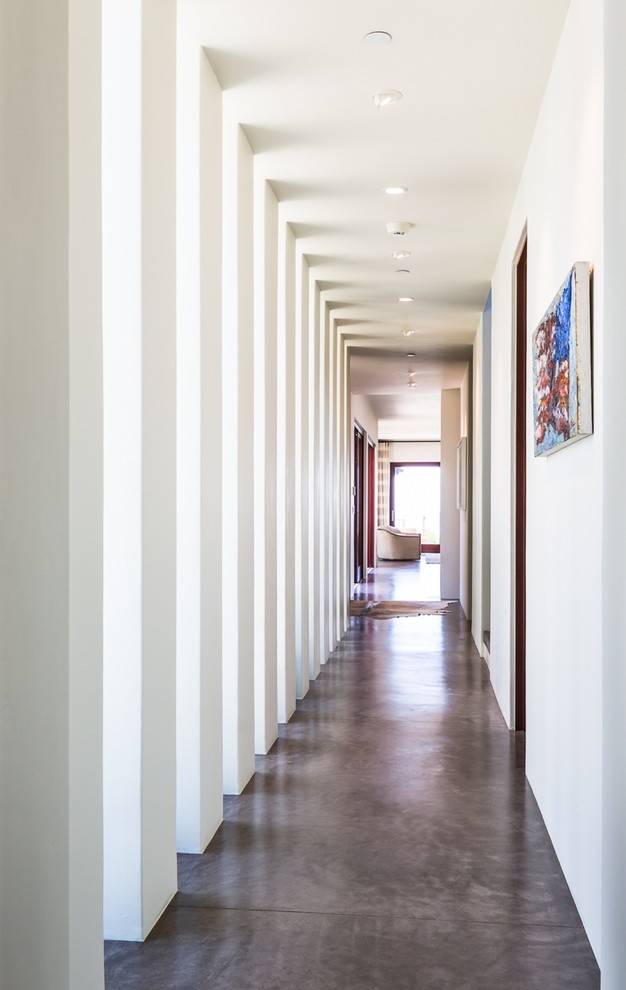 Contemporary hallway in Santa Barbara with concrete floors.